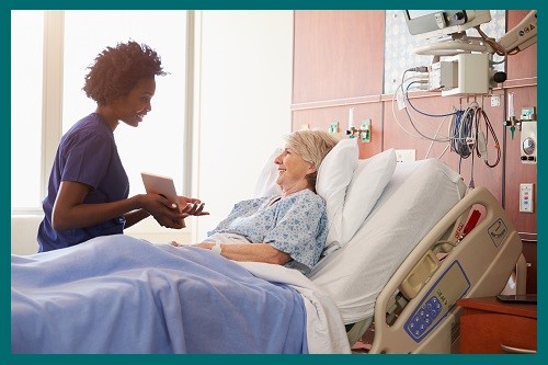 a med surg nurse talking with a patient in the hospital