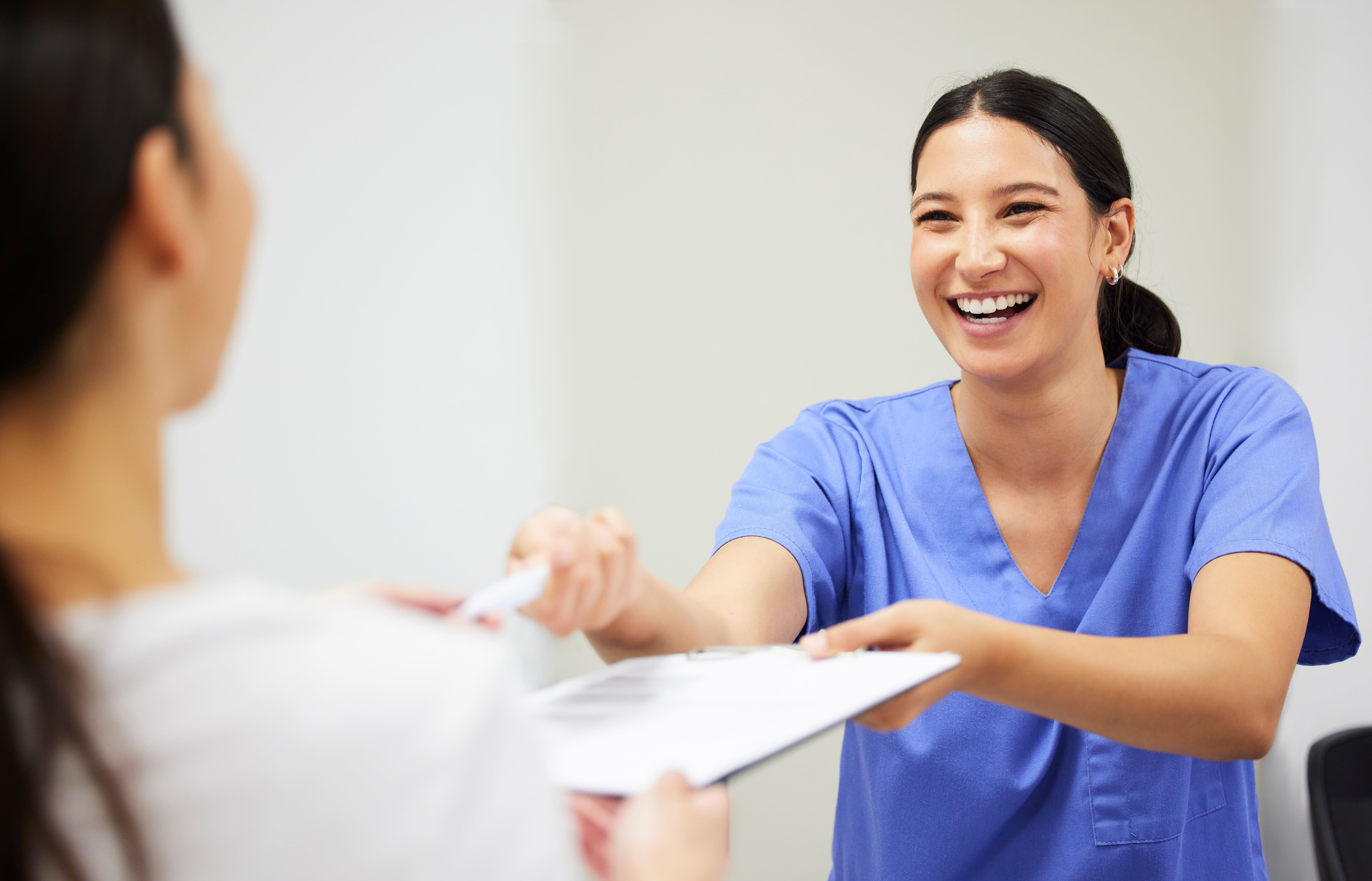 Nurse discussing paperwork with another person